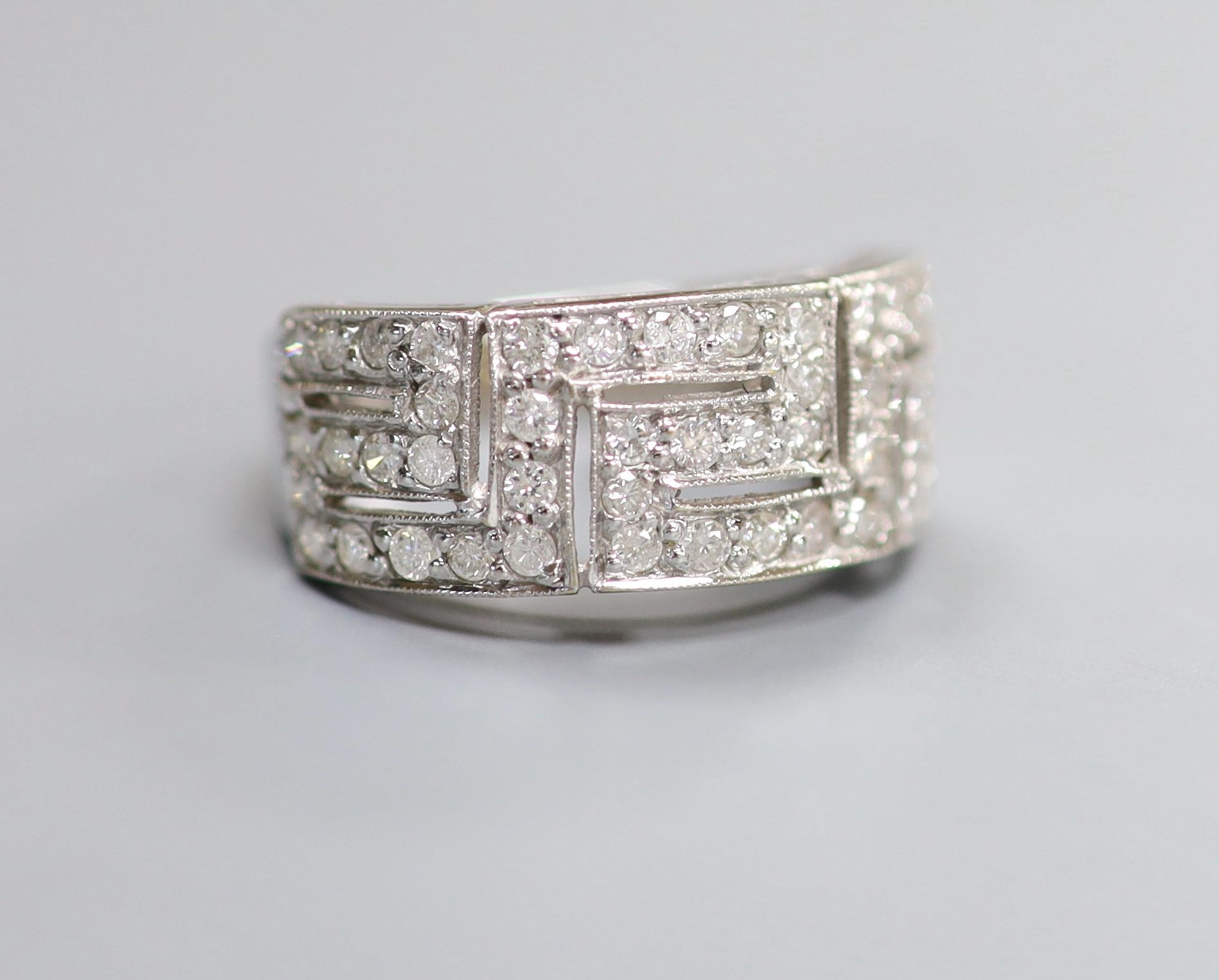 A modern 18ct white gold and diamond set 'Greek Key' dress ring, size P/Q, gross weight 5.4 grams.